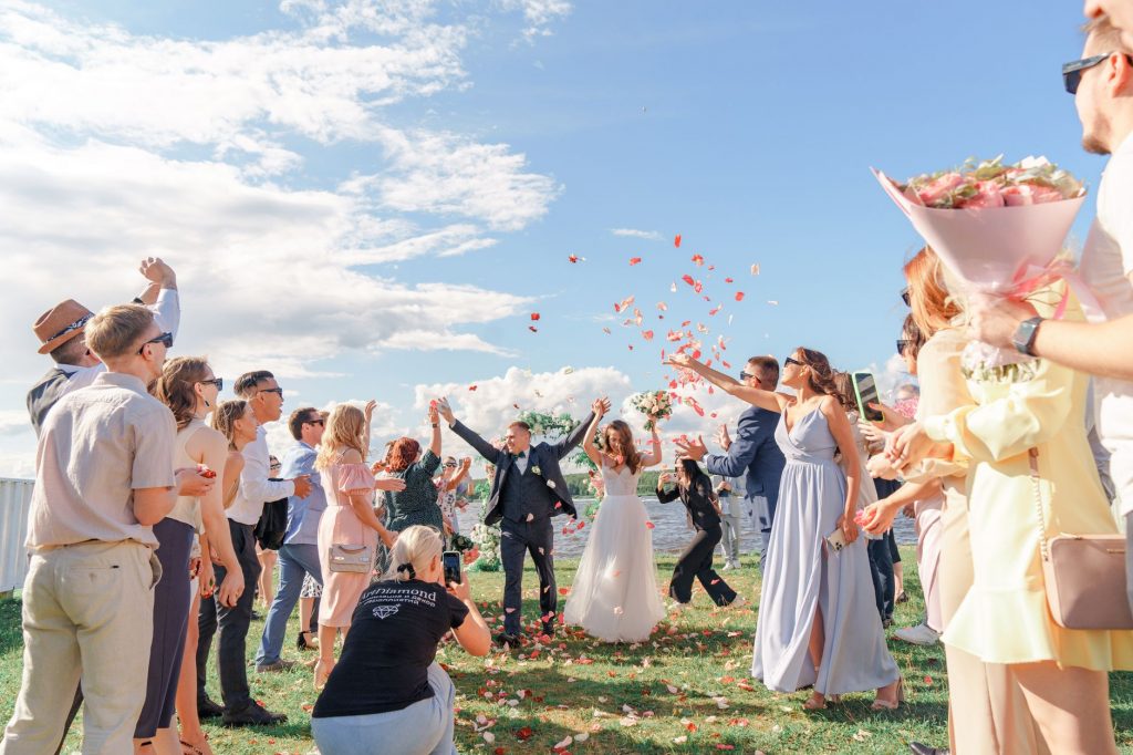 newlyweds and people under confetti